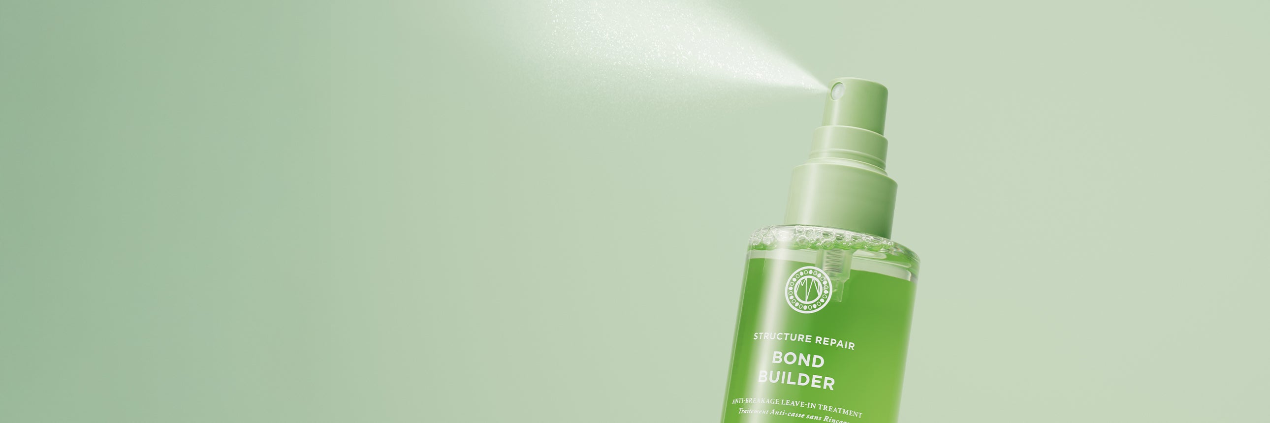 Green spray bottle with Maria Nila Bond Builder anti-breakage leave-in treatment a light green background