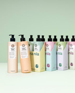 Row of Mania Nila hair care products on a light green background