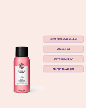 Pink Extreme Spray travel size bottle with black cap on a light pink background