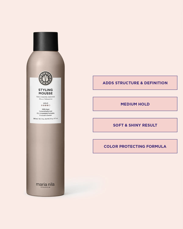 Styling mousse bottle with product details on a pink background