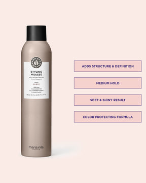 Styling mousse bottle with product details on a pink background