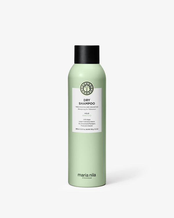 Green bottle of Maria Nila dry shampoo on a white background