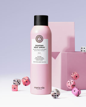 Pink Shaping Heat Spray bottle with black cap on a light purple background