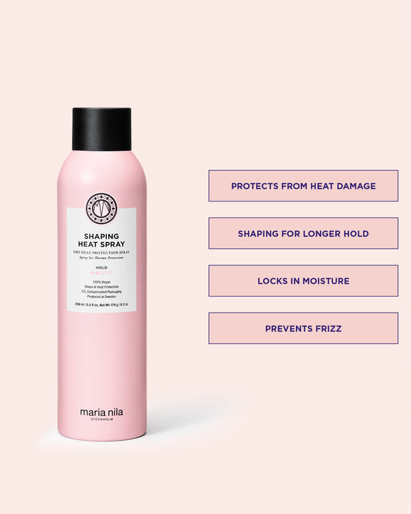 Pink Shaping Heat Spray bottle with black cap on a light pink background, featuring product USPs.