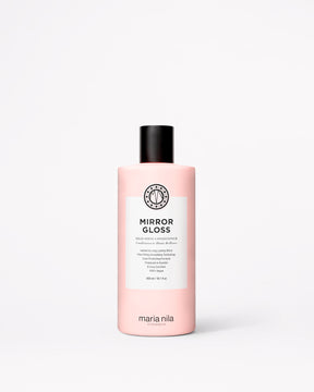 A bottle of Maria Nila Mirror Gloss Conditioner in a pale pink bottle with a black cap and white label, centered on a light gray background.