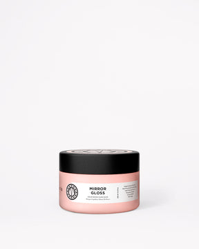 A pink jar of Maria Nila Mirror Gloss hair mask with a black lid, set against a plain white background.