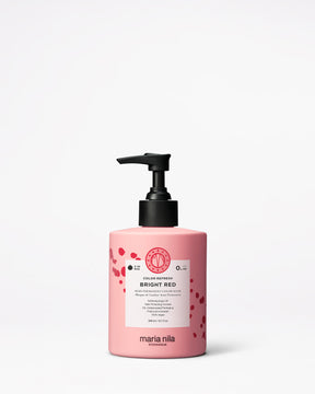 Pink hair color bottle with pump labeled 'Bright Red' by Maria Nila on a white background