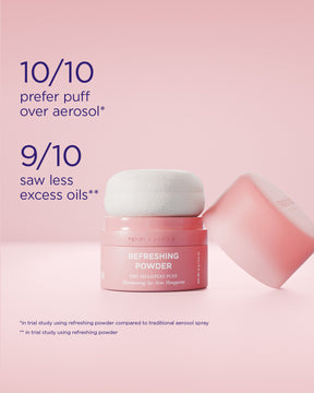 A pink jar labeled Refreshing Powder with a white puff applicator resting on top, alongside a tipped-over jar top, on a soft pink background with text about prodoct claims