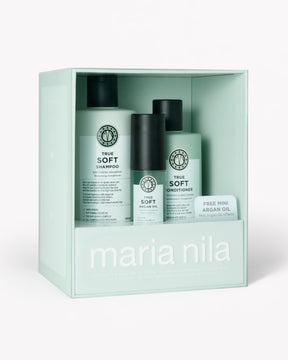 Maria Nila True Soft hair care set in a mint green gift box, featuring shampoo, conditioner, and an argan oil bottle.