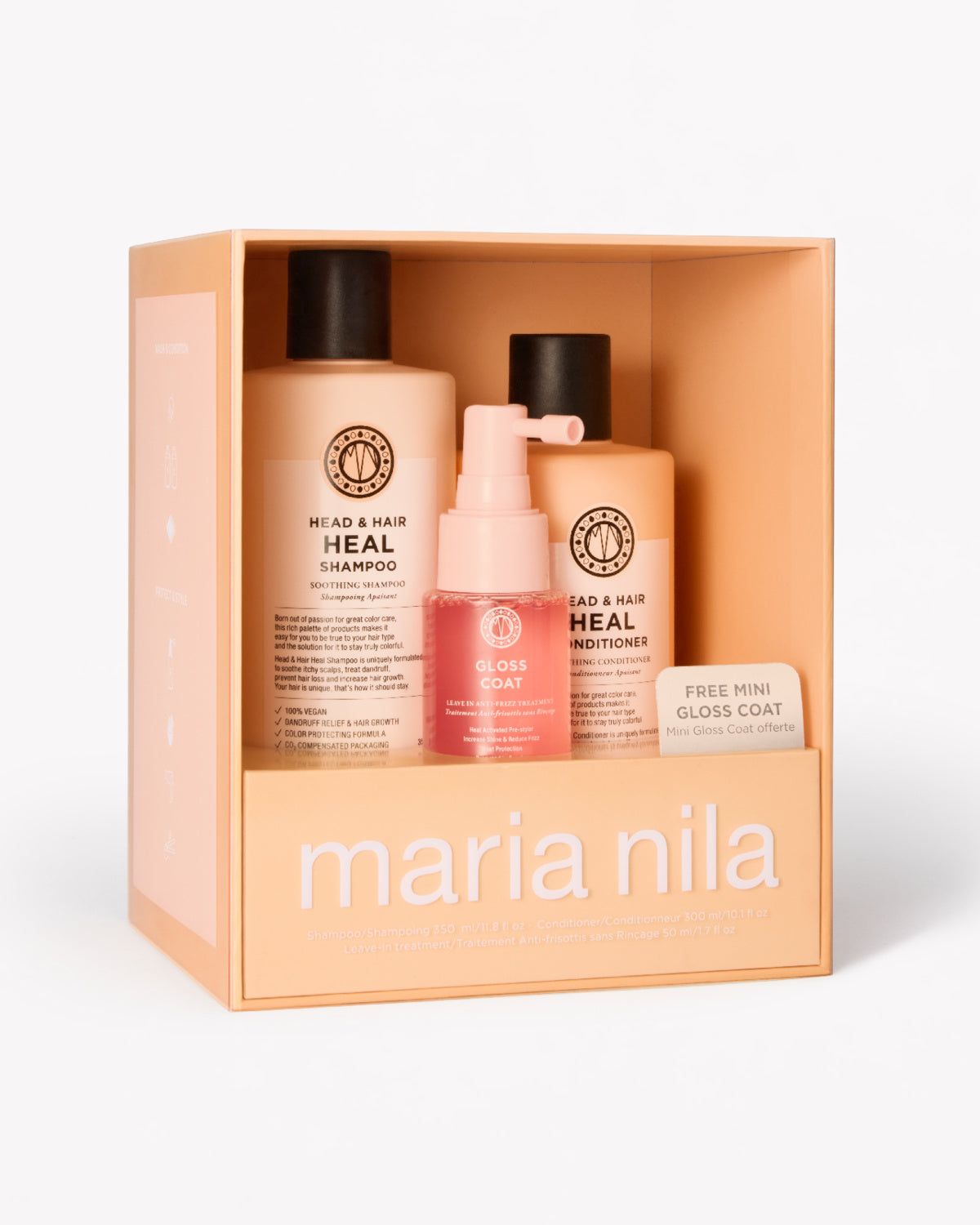 Maria Nila Head & Hair Heal gift set in a peach-colored box, containing a shampoo bottle, a conditioner bottle, a pink gloss coat spray.