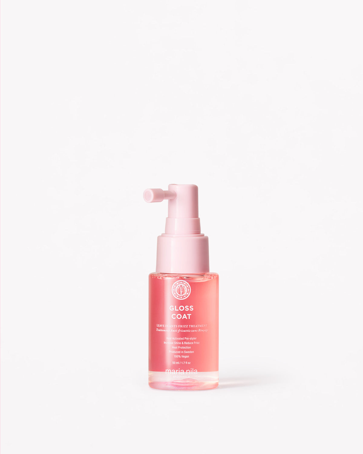 Small pink spray bottle labeled Gloss Coat Travel with white text on a clear container.