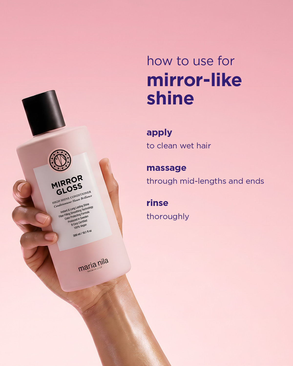Hand holding a pink bottle of Mirror Gloss Conditioner against a soft pink background with usage instructions text.