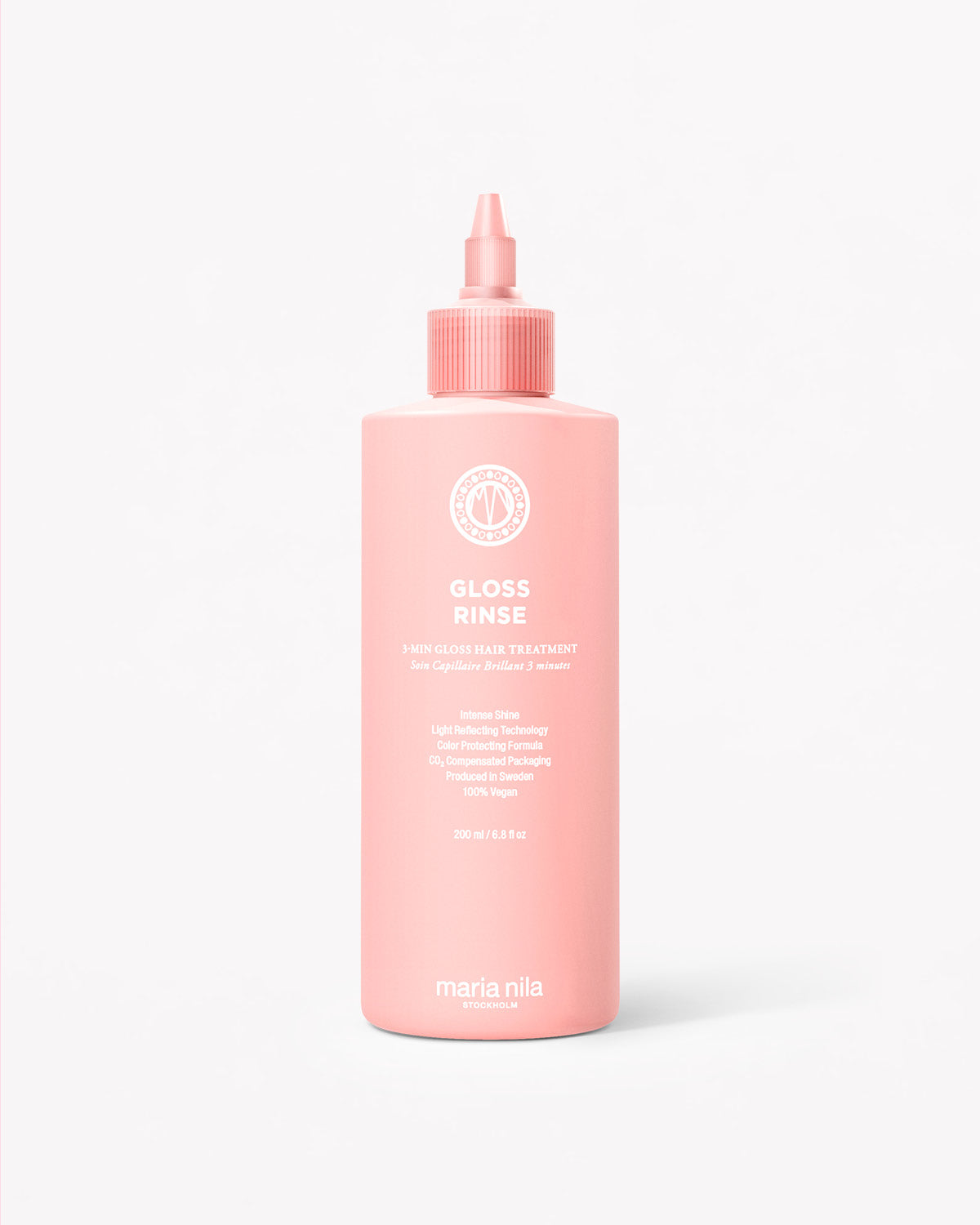 Pink plastic bottle with a pointed nozzle cap labeled Mirror Gloss Rinse gloss treatment.