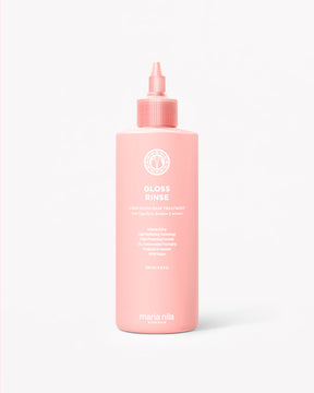 Pink plastic bottle with a pointed nozzle cap labeled Mirror Gloss Rinse gloss treatment.