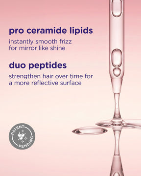 Dropper releasing clear serum with glossy reflective liquid pools on soft pink gradient background.