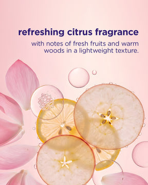 Transparent circular slices of citrus fruits with pink flower petals and water droplets on a soft pink background.