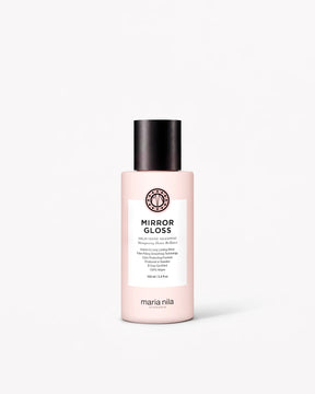 Small pale pink shampoo bottle with black cap and white label featuring black text.