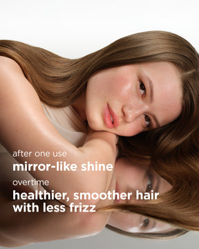 Long smooth brown hair with mirror-like shine resting on reflective surface.