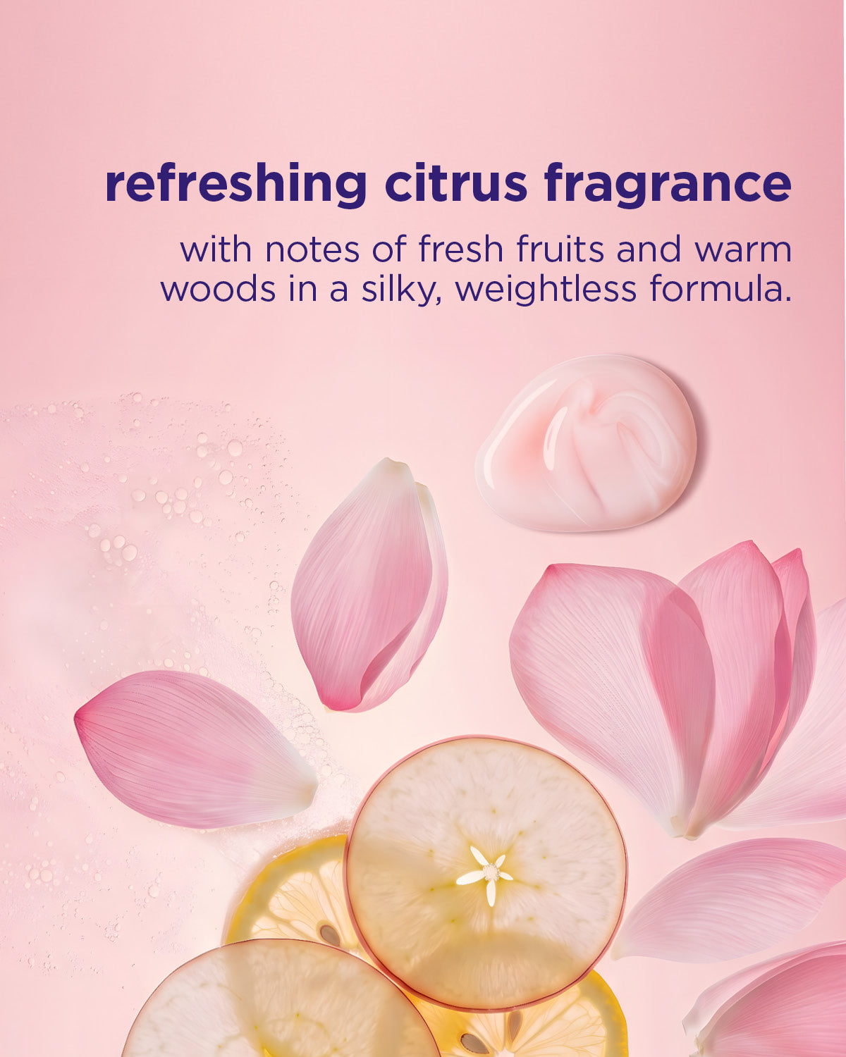 Pink creamy shampoo texture with pink flower petals and sliced citrus fruit on pink background.
