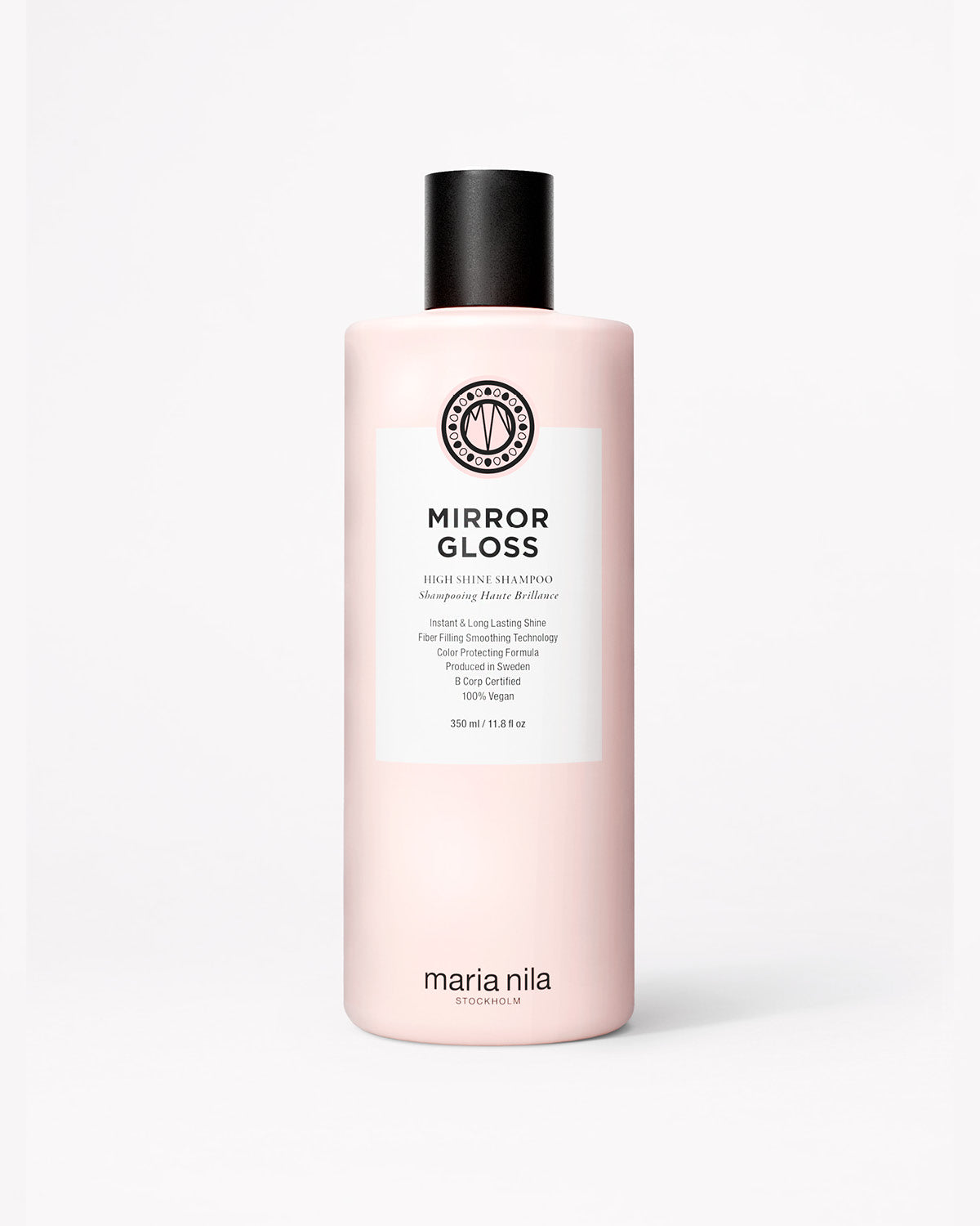 Tall pink shampoo bottle with black cap and white label reading Mirror Gloss by Maria Nila.