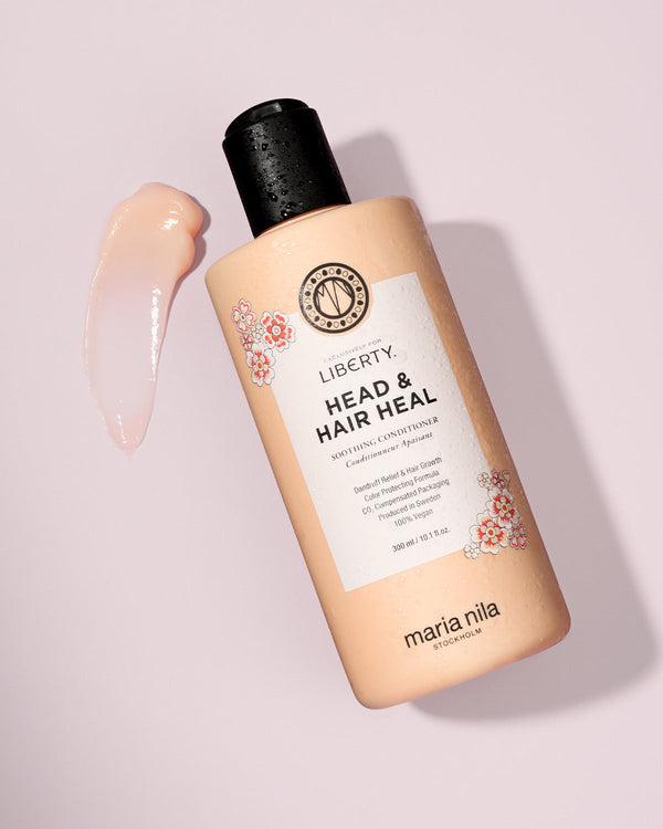 Maria Nila hair care product bottle on a light pink background